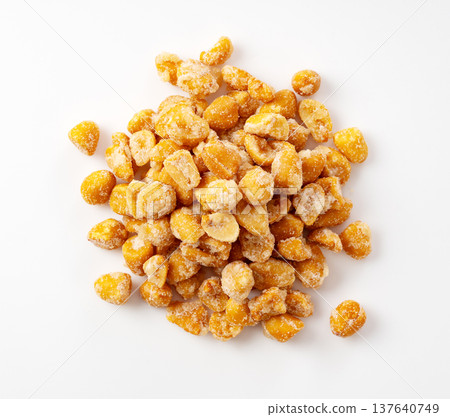 An overhead view of honey roasted peanuts on a white background 137640749