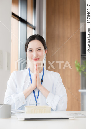 Lunch image camera of an office lady eating homemade lunch at work, putting her hands together saying "itadakimasu" or "gochisousama" Lunch image camera of an office lady eating homemade lunch at work, putting her hands together saying "itadakimasu" or "gochisousama" 137640947