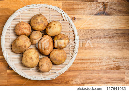 New potatoes placed on a sieve 137641083