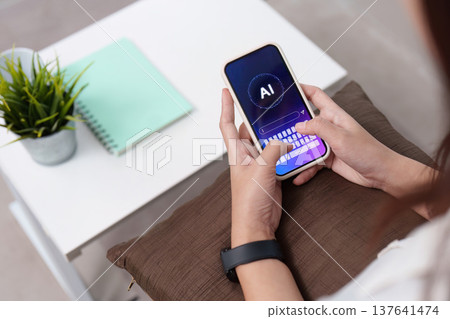 AI Technology. Woman using smartphone to access AI features. AI Technology. Woman using smartphone to access AI features. 137641474