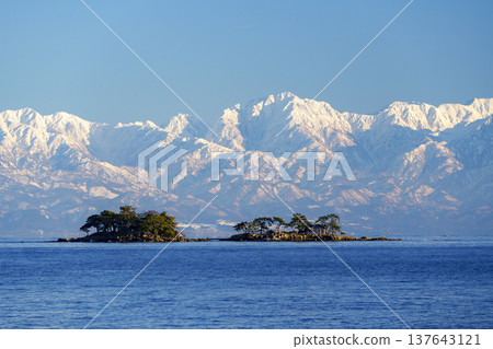 A spectacular view of Abugashima Island floating in Toyama Bay and the Tateyama mountain range. A spectacular view of Abugashima Island floating in Toyama Bay and the Tateyama mountain range. 137643121