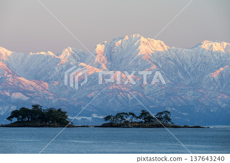 A spectacular view of Abugashima Island floating in Toyama Bay and the Tateyama mountain range. A spectacular view of Abugashima Island floating in Toyama Bay and the Tateyama mountain range. 137643240