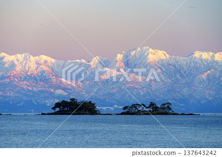 A spectacular view of Abugashima Island floating in Toyama Bay and the Tateyama mountain range. A spectacular view of Abugashima Island floating in Toyama Bay and the Tateyama mountain range. 137643242