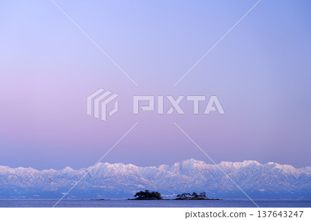 A spectacular view of Abugashima Island floating in Toyama Bay and the Tateyama mountain range. A spectacular view of Abugashima Island floating in Toyama Bay and the Tateyama mountain range. 137643247