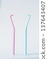 Two single tuft toothbrushes in pink and blue on light background, dental hygiene tools minimal concept 137643407