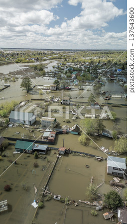 Spring flood disaster with fully submerged houses, flooded roads and overflowing waterways. The footage shows the dramatic impact of heavy rainfall and rising water levels on residential areas Spring flood disaster with fully submerged houses, flooded roads and overflowing waterways. The footage shows the dramatic impact of heavy rainfall and rising water levels on residential areas 137643600