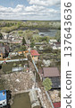 Spring flood disaster with fully submerged houses, flooded roads and overflowing waterways. The footage shows the dramatic impact of heavy rainfall and rising water levels on residential areas 137643636