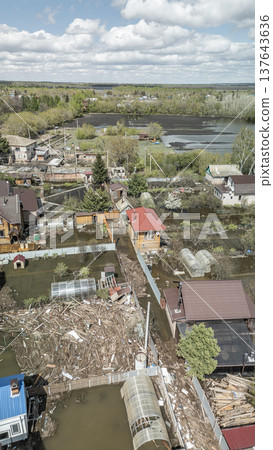 Spring flood disaster with fully submerged houses, flooded roads and overflowing waterways. The footage shows the dramatic impact of heavy rainfall and rising water levels on residential areas Spring flood disaster with fully submerged houses, flooded roads and overflowing waterways. The footage shows the dramatic impact of heavy rainfall and rising water levels on residential areas 137643636