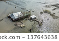 Spring flood disaster with fully submerged houses, flooded roads and overflowing waterways. The footage shows the dramatic impact of heavy rainfall and rising water levels on residential areas 137643638