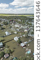 Spring flood disaster with fully submerged houses, flooded roads and overflowing waterways. The footage shows the dramatic impact of heavy rainfall and rising water levels on residential areas 137643646