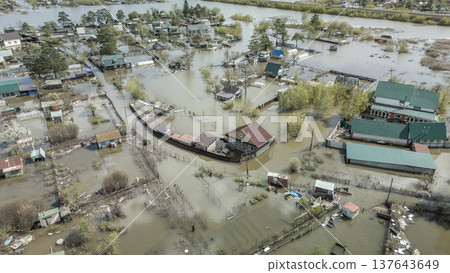 Spring flood disaster with fully submerged houses, flooded roads and overflowing waterways. The footage shows the dramatic impact of heavy rainfall and rising water levels on residential areas Spring flood disaster with fully submerged houses, flooded roads and overflowing waterways. The footage shows the dramatic impact of heavy rainfall and rising water levels on residential areas 137643649