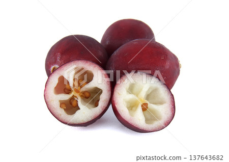 Whole and halved cranberries revealing their internal structure and seeds on a white background Whole and halved cranberries revealing their internal structure and seeds on a white background 137643682