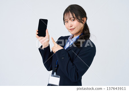 Business woman operating a smartphone Business woman operating a smartphone 137643911