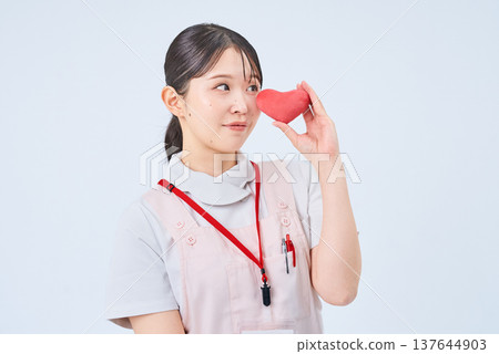 一個穿著白大褂和圍裙的年輕女子 一個穿著白大褂和圍裙的年輕女子 137644903
