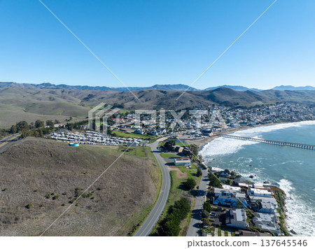 Aerial view of Cayucos, California USA, Pier, Ocean Ave and Shoreline Beach with Green Hills in San Luis Obispo County 137645546