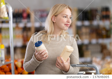 Young woman choosing mayonnaise in grocery store 137646005