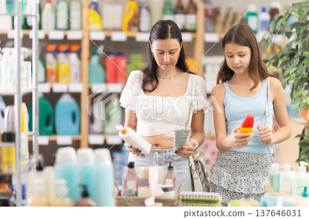 Woman with daughter choosing sunscreen in store 137646031