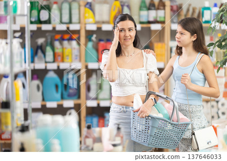 Upset and tired mother with shopping basket argues with her teen daughter Upset and tired mother with shopping basket argues with her teen daughter 137646033