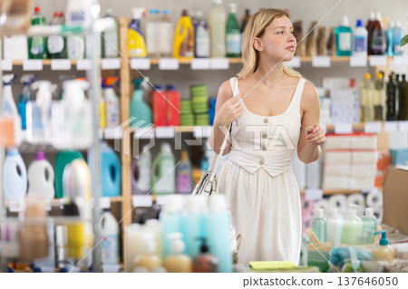 Portrait of girl shopper choosing some products in supermarket Portrait of girl shopper choosing some products in supermarket 137646050