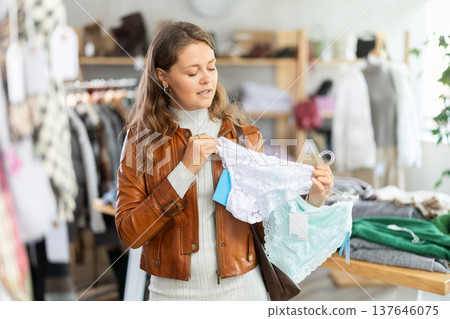 Young woman chooses panties in clothing store 137646075