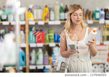 woman choosing tanning products and sun protection 137646093