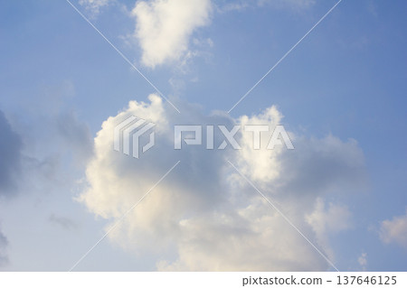 It's a blue sky with atmospheric puffy clouds. It's a blue sky with atmospheric puffy clouds. 137646125