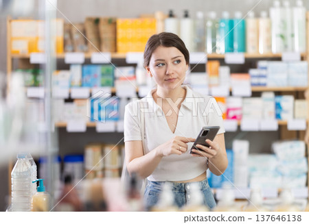 Portrait of girl in summer clothes shopper choosing some products in supermarket Portrait of girl in summer clothes shopper choosing some products in supermarket 137646138