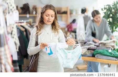 Uncertain young girl choosing panties in clothing store Uncertain young girl choosing panties in clothing store 137646441