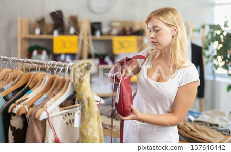 Woman choosing a handbag on sale 137646442