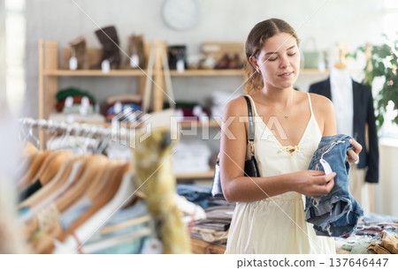 Young woman choosing denim shorts 137646447