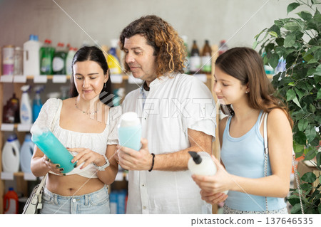 Teenage girl with parents choosing shower gel in personal care store Teenage girl with parents choosing shower gel in personal care store 137646535