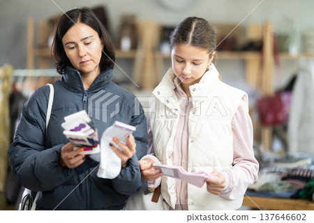 Adult woman and teenage girl choose socks 137646602