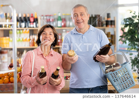 Senior couple hold bottle and choose consider alcohol beer in store Senior couple hold bottle and choose consider alcohol beer in store 137646614