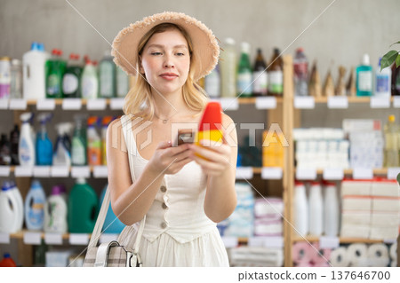 customer scans a package with a repellent on her phone 137646700