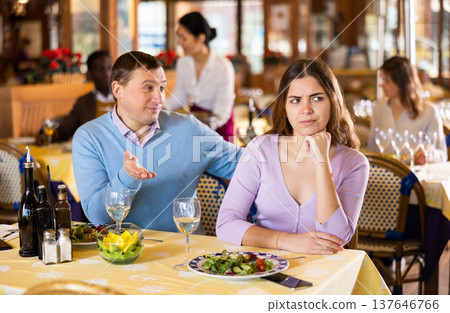 Man and his wife quarreling in restaurant Man and his wife quarreling in restaurant 137646766