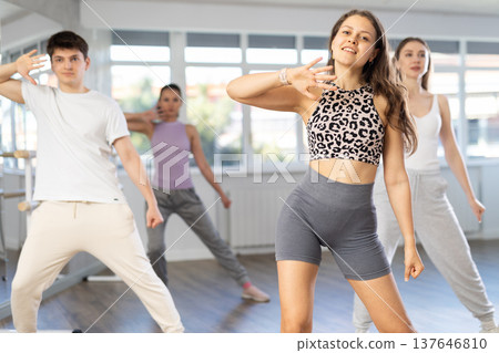 Group of men and women dance an energetic hip-hop dance in studio. Modern dance lesson 137646810