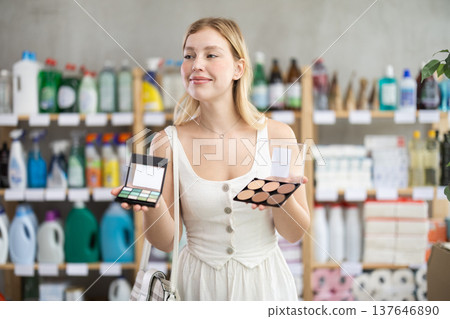 Interested young woman picking beauty products in store Interested young woman picking beauty products in store 137646890