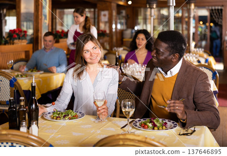 Man and woman chatting while having dinner in restaurant Man and woman chatting while having dinner in restaurant 137646895