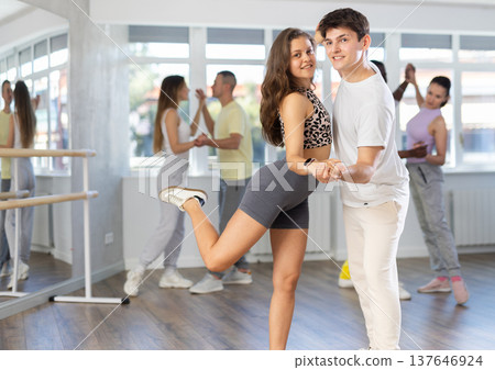 Ordinary adults dancing bachata together in dance studio Ordinary adults dancing bachata together in dance studio 137646924