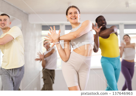 European girl with team of like-minded multinational people learn to elements of electro dance European girl with team of like-minded multinational people learn to elements of electro dance 137646963