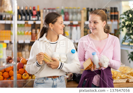 Young women choosing dairy products in grocery store 137647056