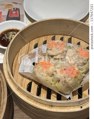 Korean dumplings filled with a mix of savory ingredients like ground meat, tofu, and vegetables. Mandu can be steamed, boiled, or pan-fried, making it a versatile and delicious snack or meal. Korean dumplings filled with a mix of savory ingredients like ground meat, tofu, and vegetables. Mandu can be steamed, boiled, or pan-fried, making it a versatile and delicious snack or meal. 137647281