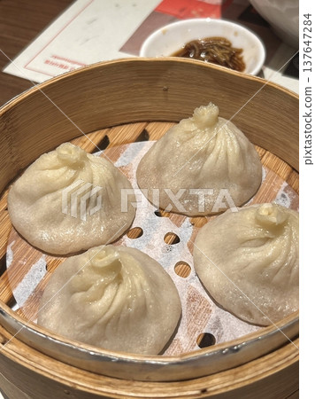 Korean dumplings filled with a mix of savory ingredients like ground meat, tofu, and vegetables. Mandu can be steamed, boiled, or pan-fried, making it a versatile and delicious snack or meal. Korean dumplings filled with a mix of savory ingredients like ground meat, tofu, and vegetables. Mandu can be steamed, boiled, or pan-fried, making it a versatile and delicious snack or meal. 137647284