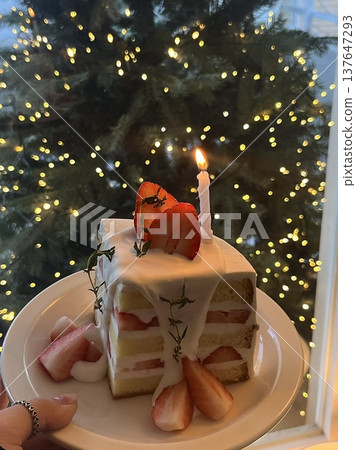 Strawberry cake with soft fluffy layers, topped with fresh strawberries and smooth cream, showcasing vibrant red fruit, delicate textures, and sweet inviting appearance in close-up detail 137647293