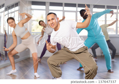 Young Asian man practicing modern street dancing in studio Young Asian man practicing modern street dancing in studio 137647337