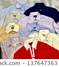 Stack of neatly folded clothes in various colors and fabrics, showing layered textures, soft materials, and stylish casual outfits prepared for daily wear, highlighting a trendy OOTD concept in detail 137647363