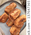 Pisang goreng made from ripe bananas coated in batter and deep-fried until golden brown, creating a crispy outer layer with sweet soft inside, served as a popular traditional snack 137647365