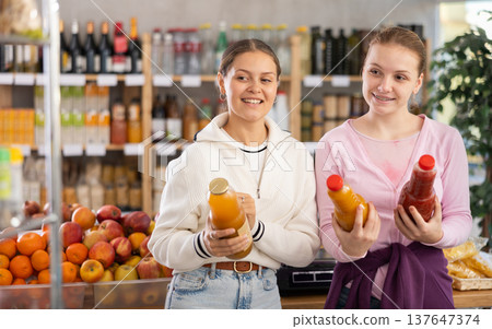 Two customers choose natural juices Two customers choose natural juices 137647374
