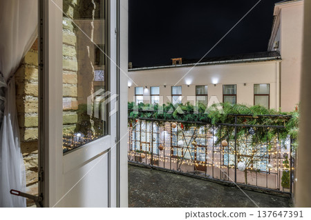 Festive Night City View from Window with Christmas Decorations Festive Night City View from Window with Christmas Decorations 137647391