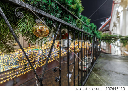 Festive Christmas Decorations on Wrought Iron Balcony at Night Festive Christmas Decorations on Wrought Iron Balcony at Night 137647413